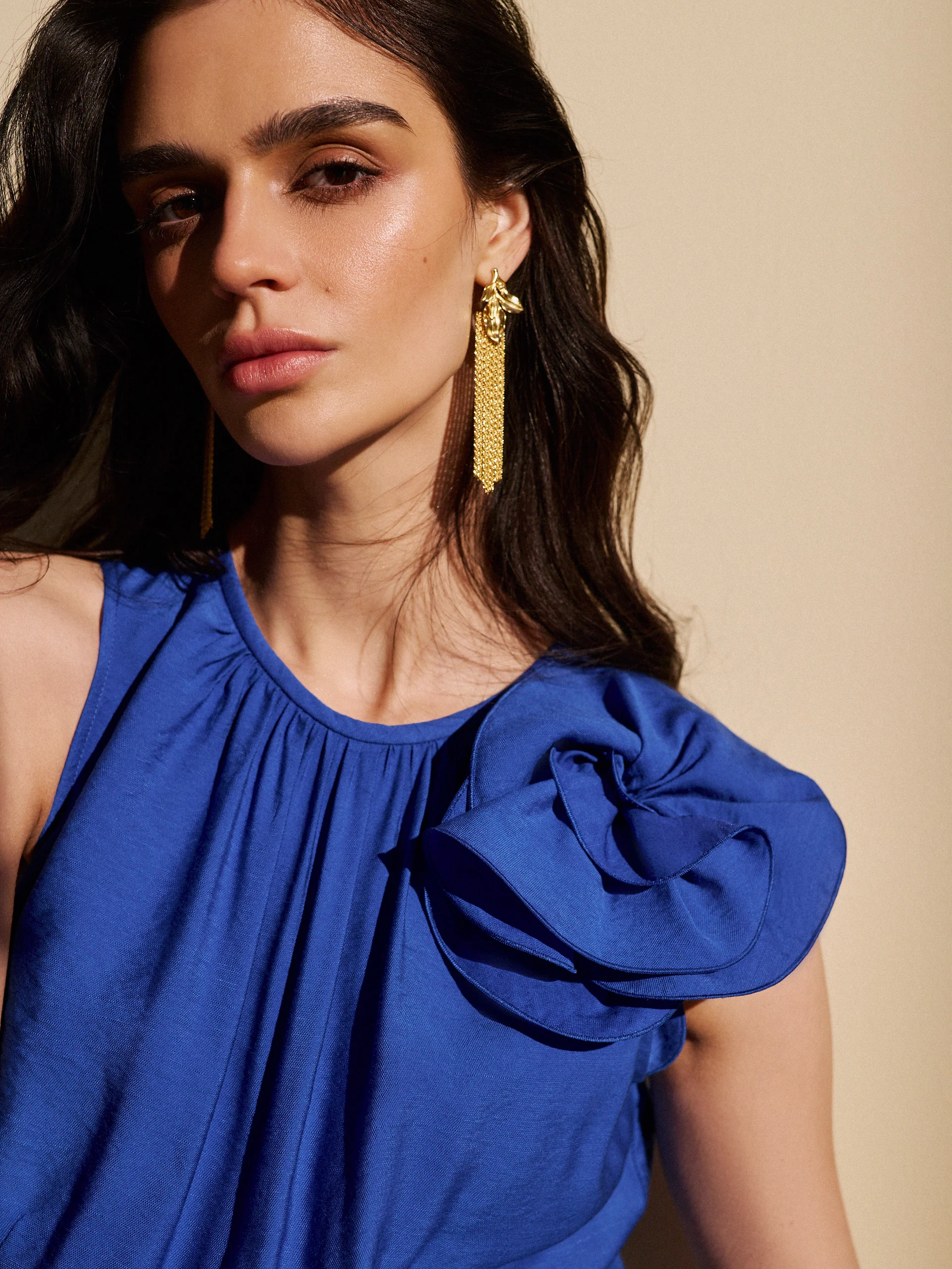 Long gold-colored earrings