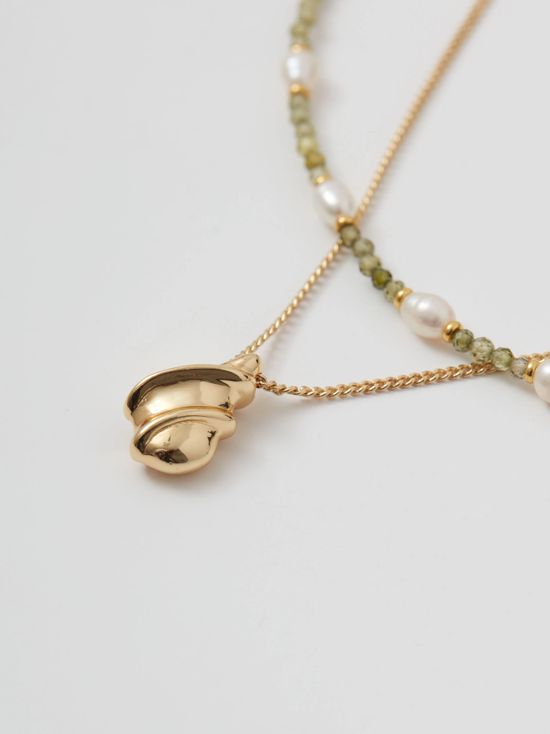 Double gold-plated necklace with pendant and green stones
