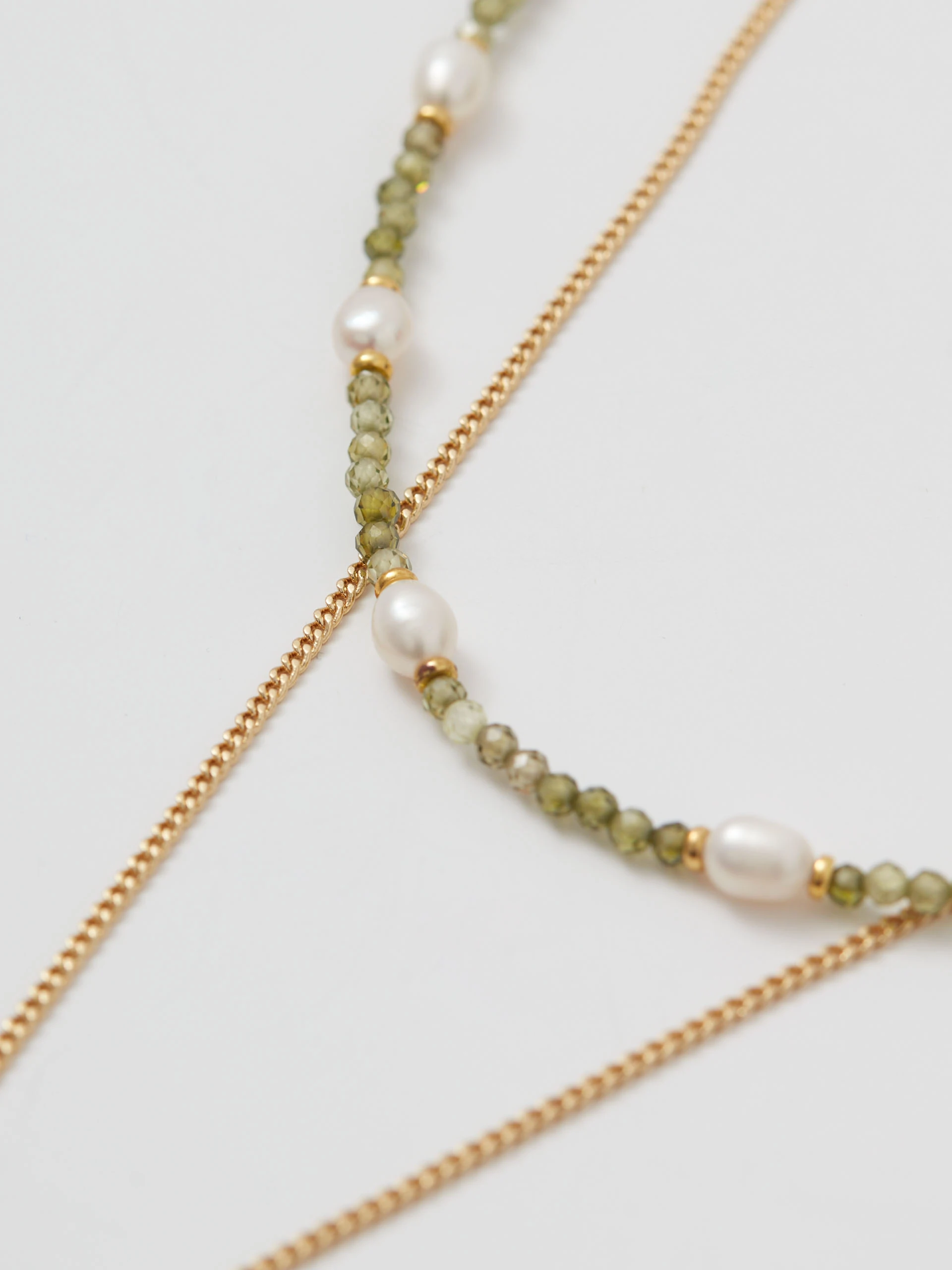 Double gold-plated necklace with pendant and green stones