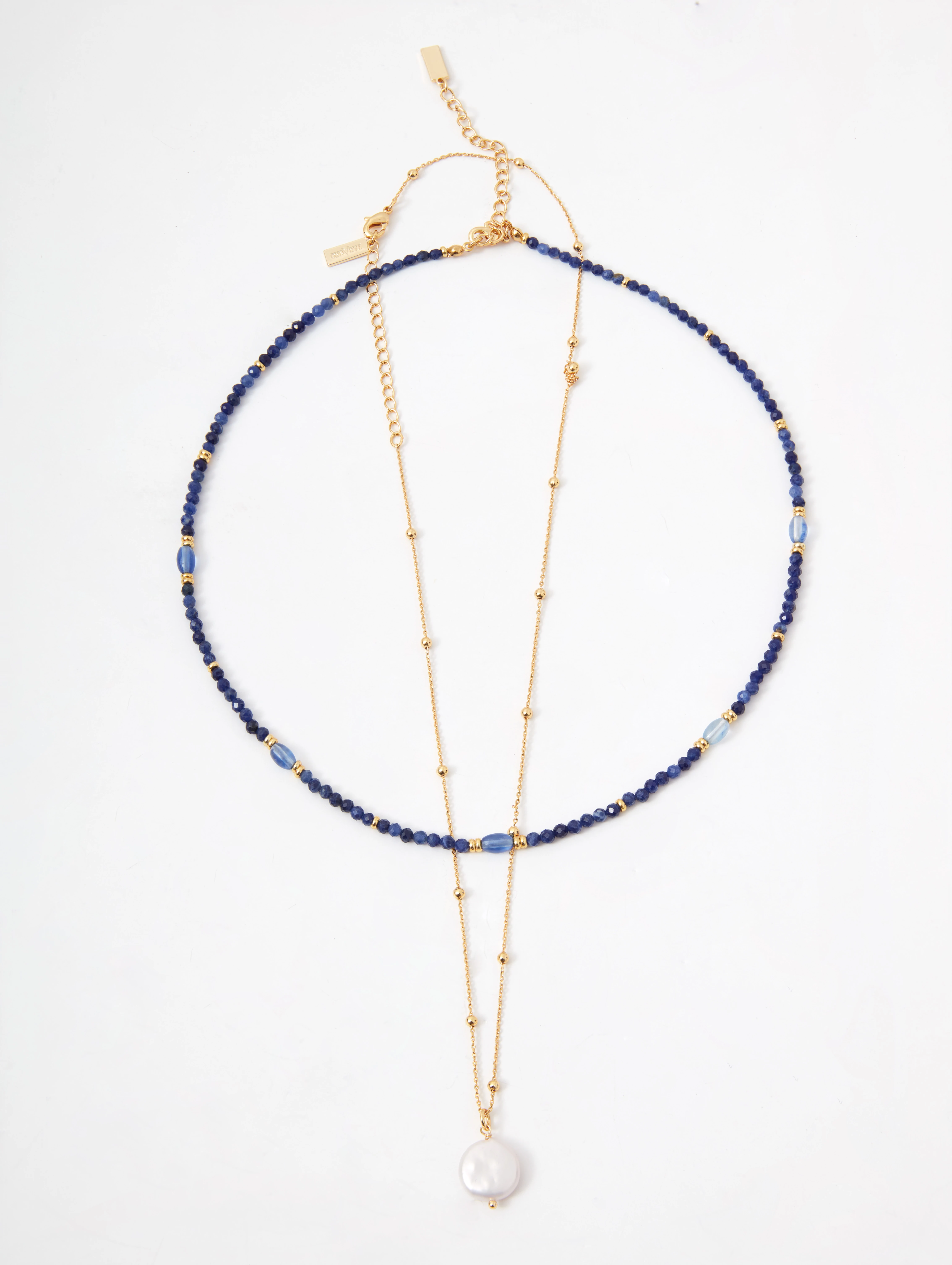 A set of two beaded necklaces with gold-colored pendants