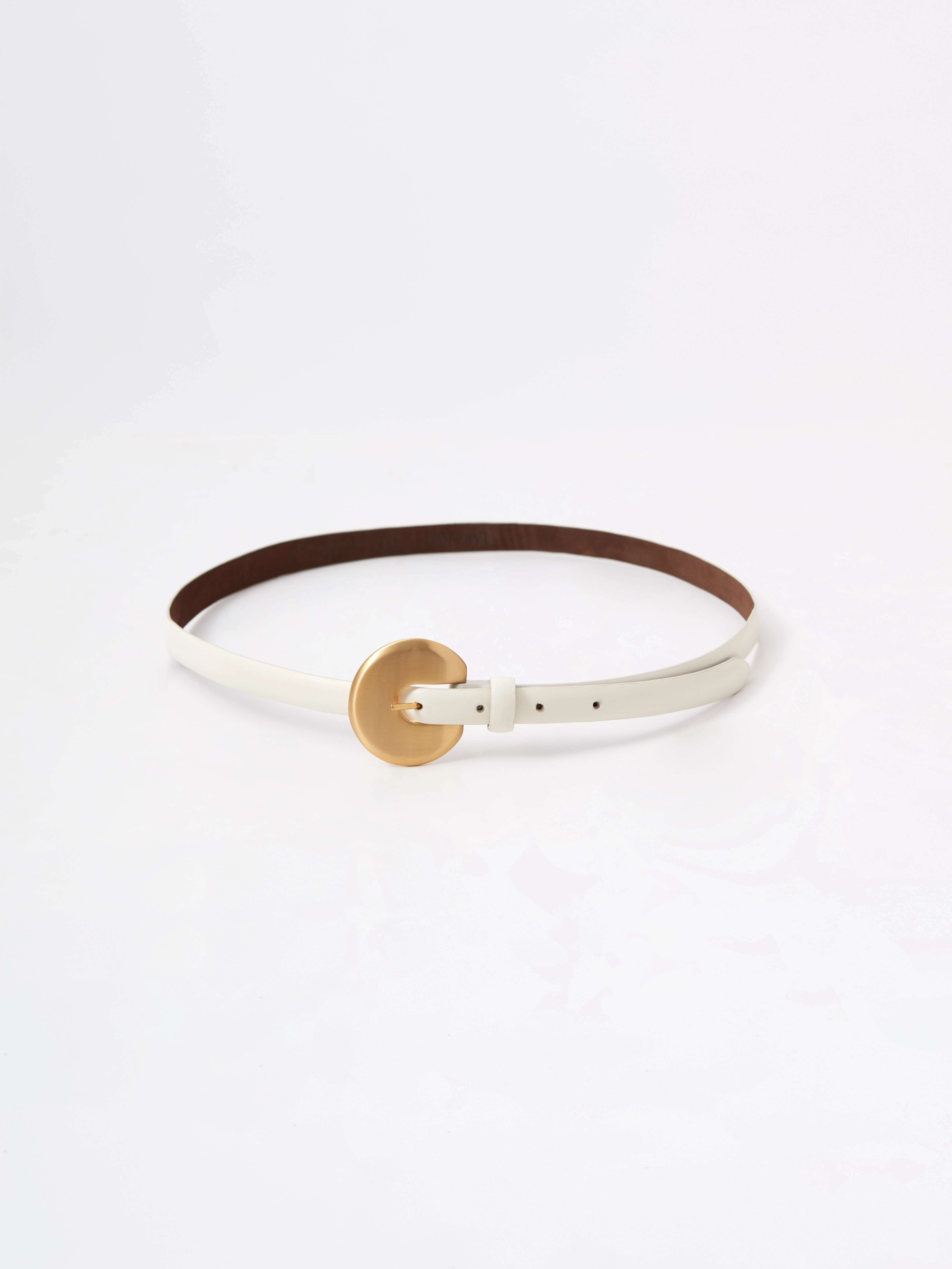 A thin, creamy-colored strap made of bombato leather