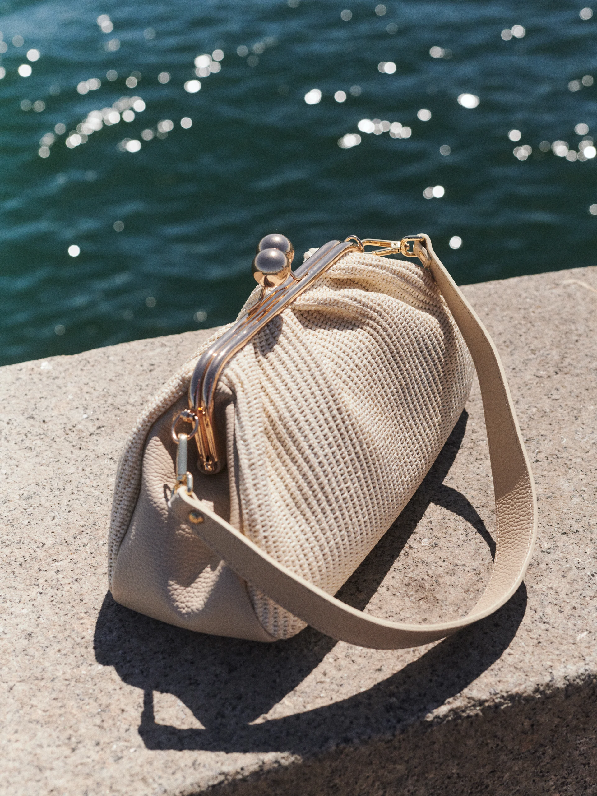 Cream-colored leather handbag with woven detailing