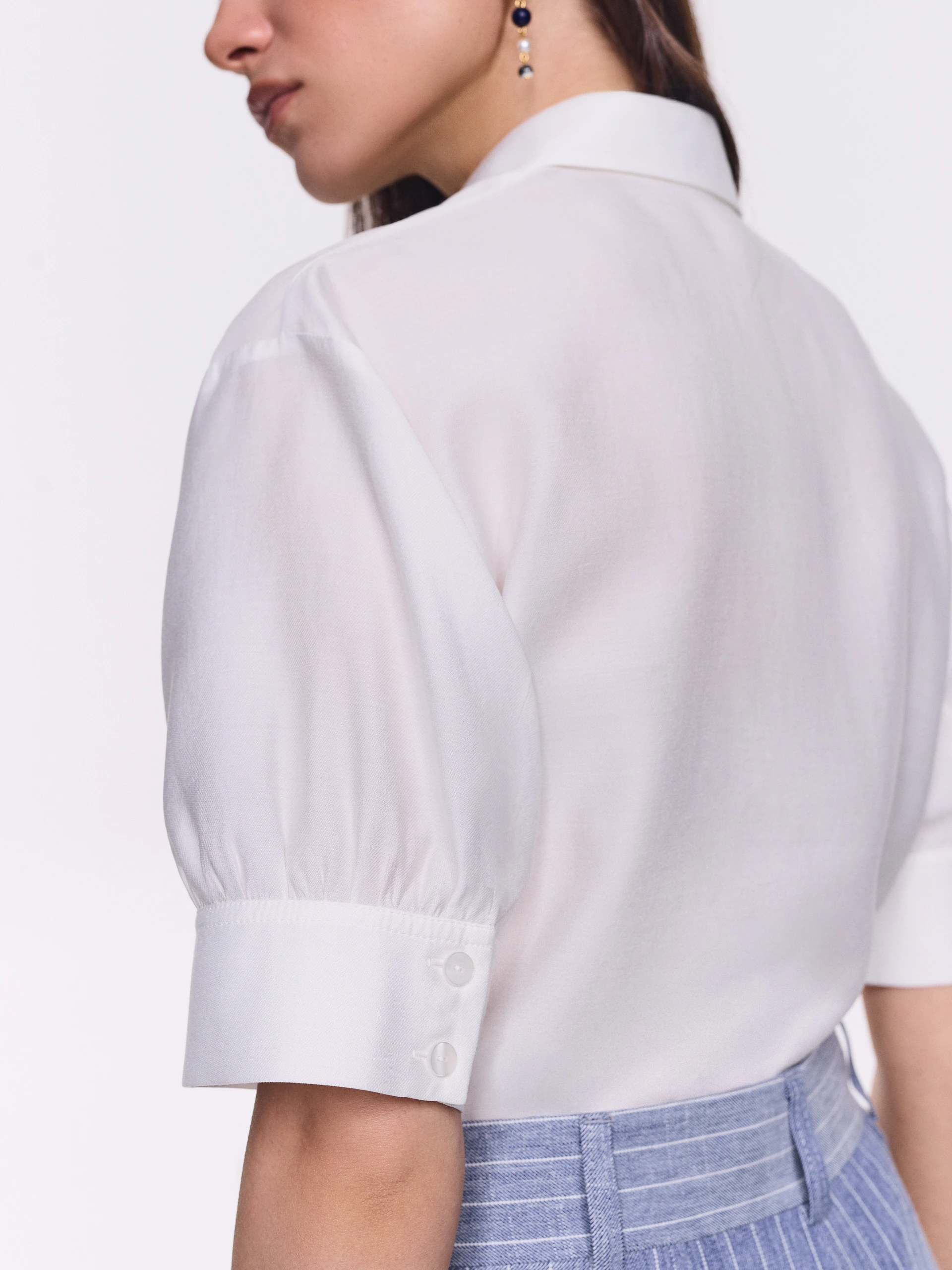 An elegant white short-sleeved shirt