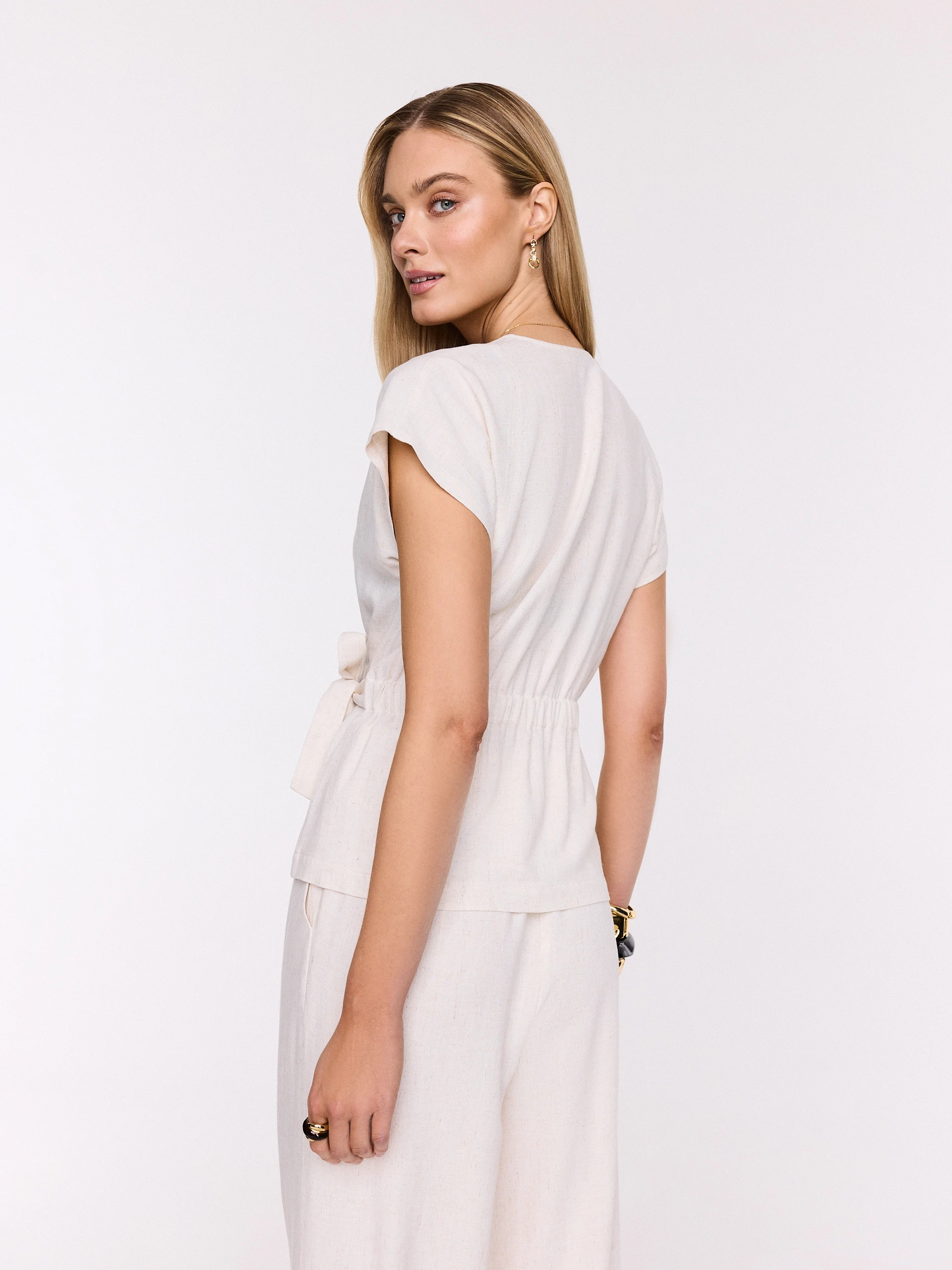 Light beige wrap blouse with a tie at the waist