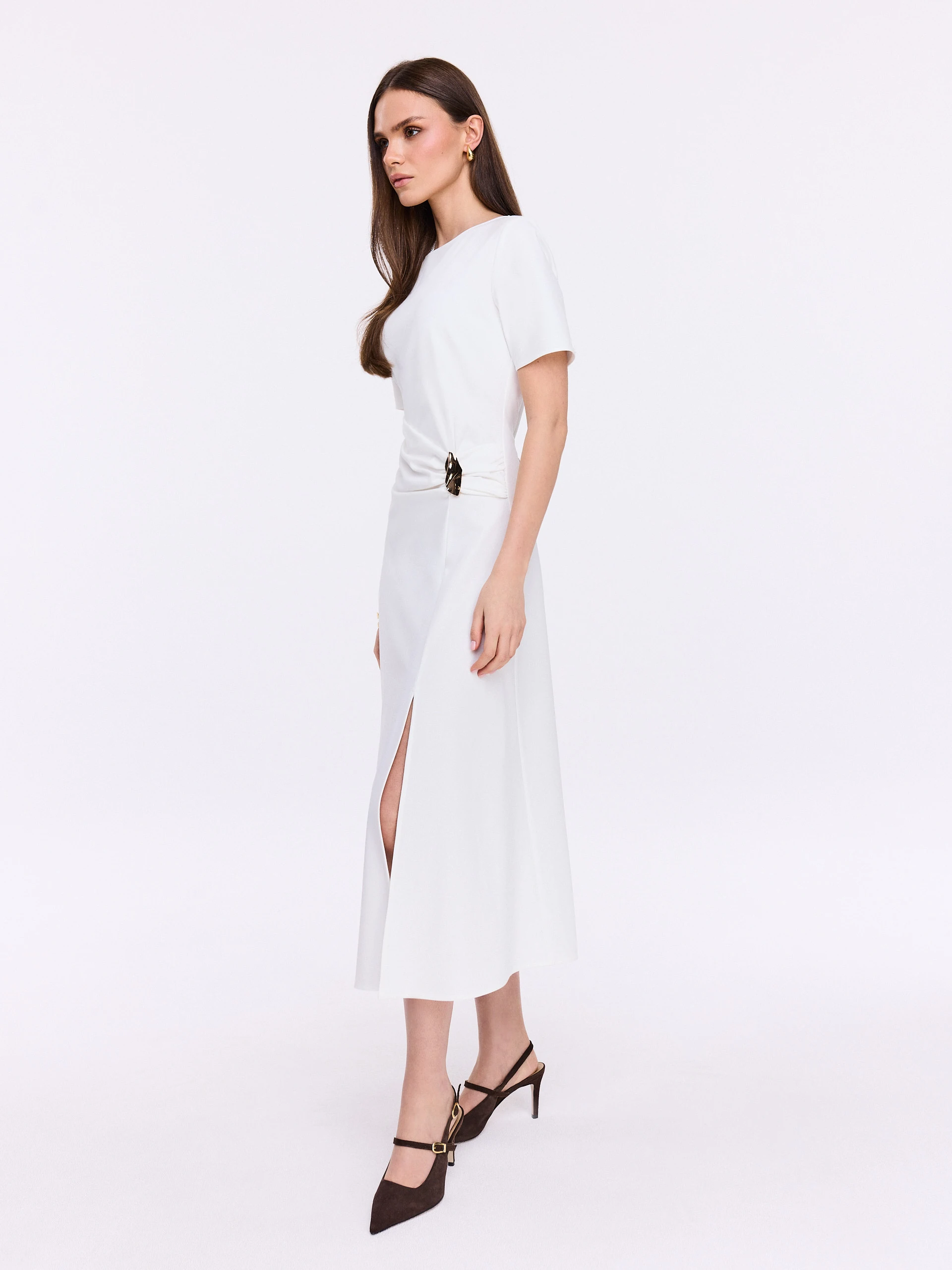 White dress with ruffles and decorative buckle