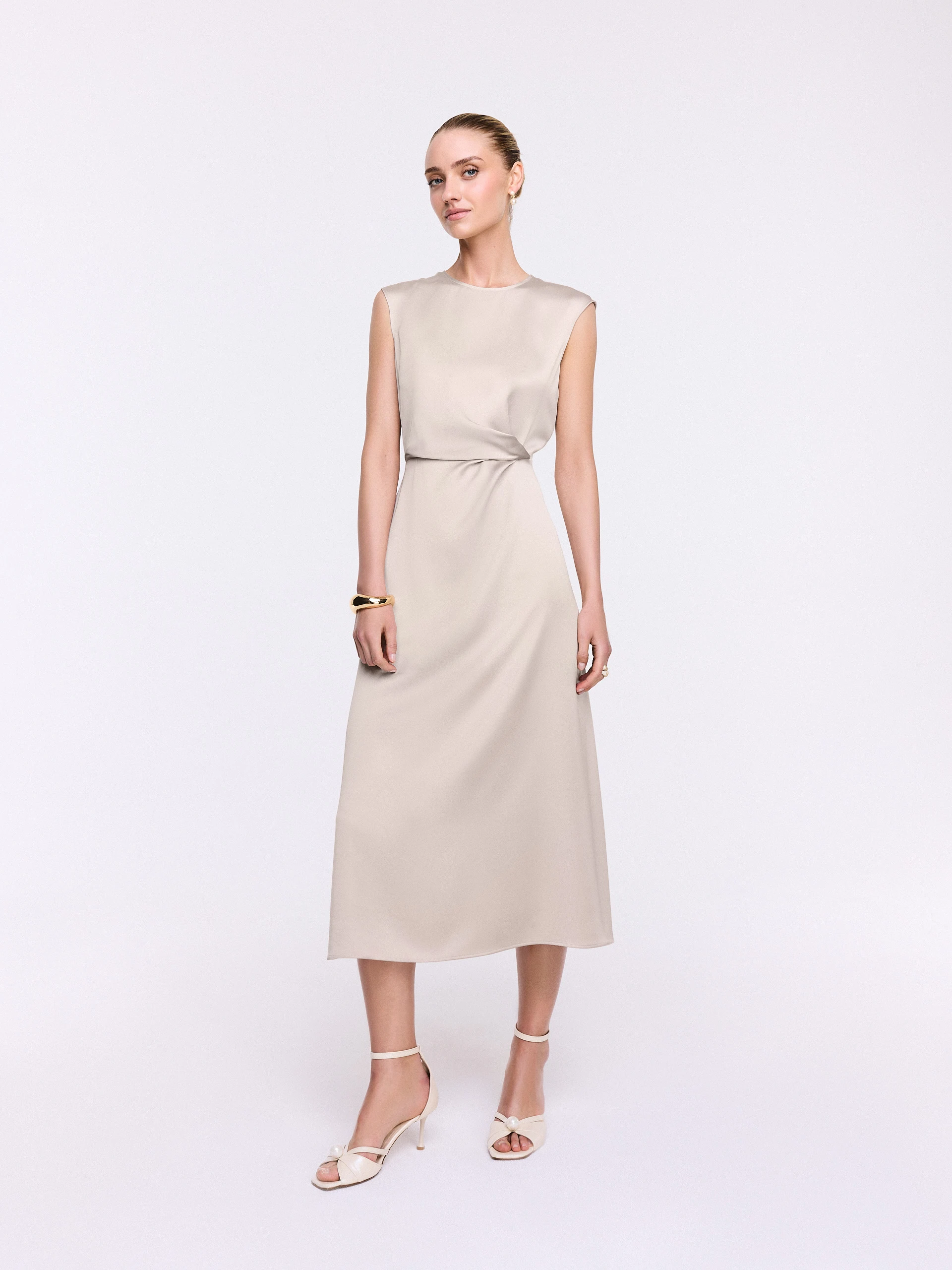 A midi dress with subtle ruffles in a champagne shade