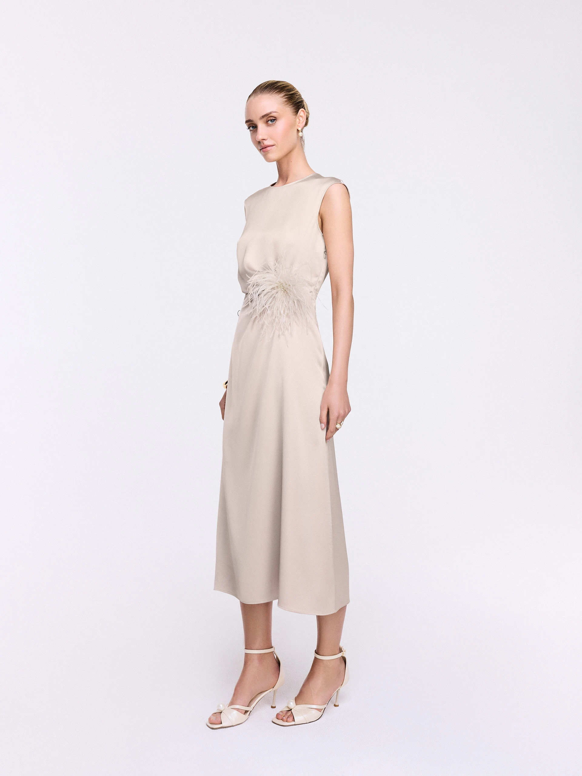 A midi dress with subtle ruffles in a champagne shade