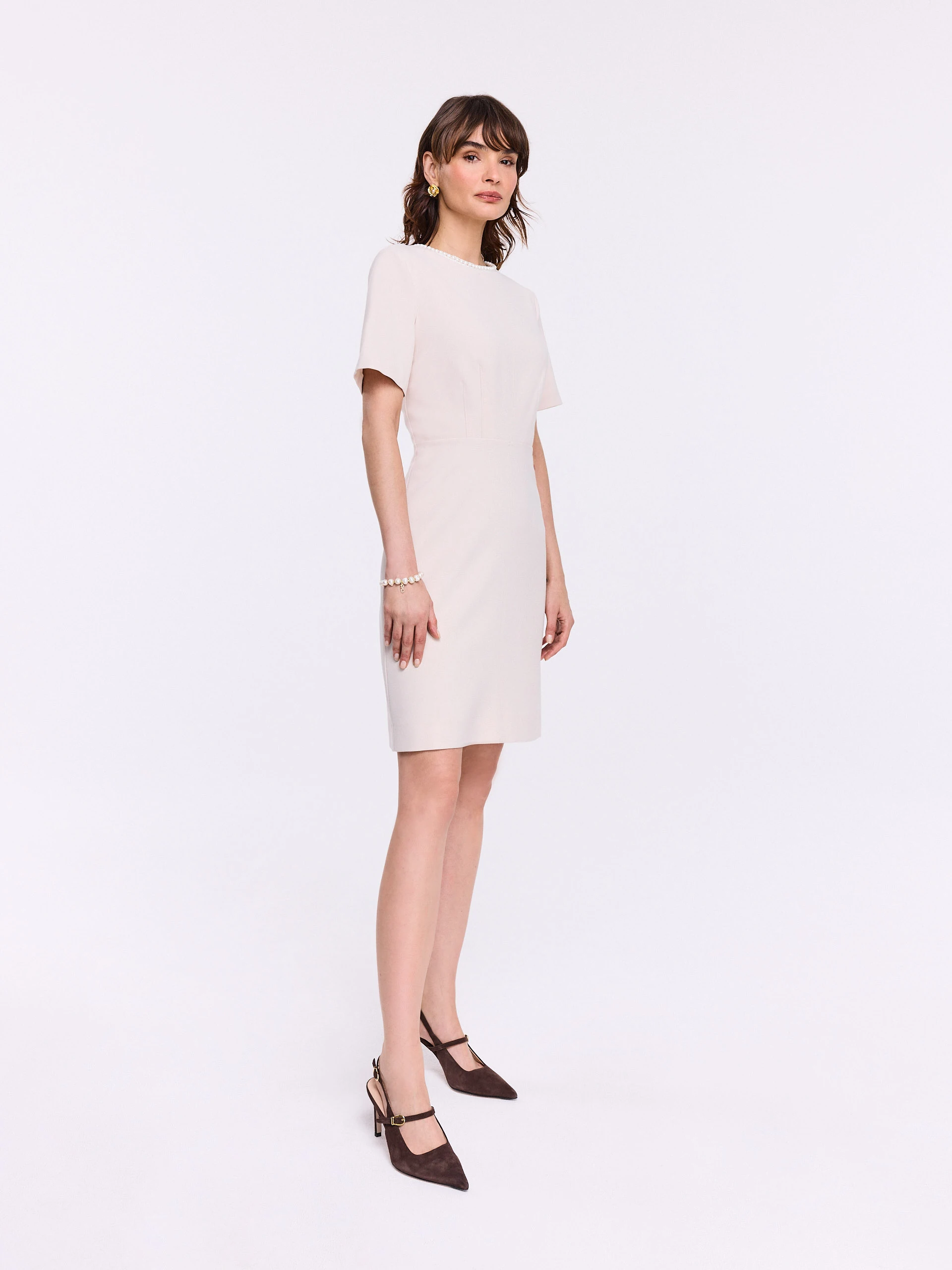 Beige dress with pearls at the collar