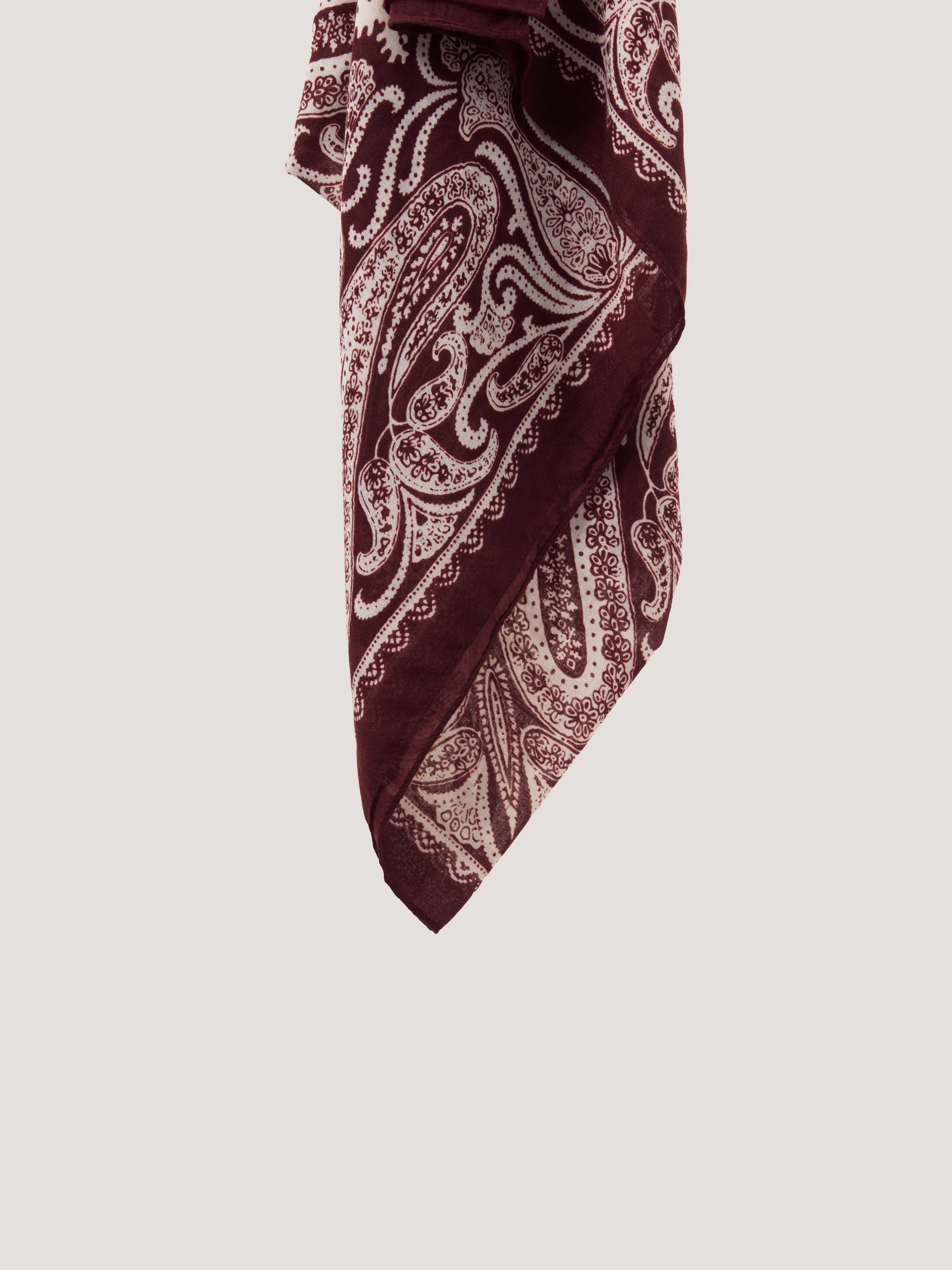 A burgundy and cream paisley-patterned scarf