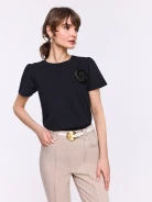 Black short-sleeved blouse with a flower-shaped brooch
