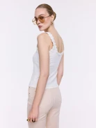 Cream-colored cotton top with decorative flowers