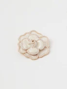 Flower-shaped brooch decorated with pearl beads