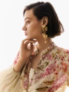 Long gold-plated earrings with decorative flowers