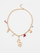 A gold-colored necklace with decorative pendants featuring a natural pearl