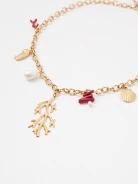 A gold-colored necklace with decorative pendants featuring a natural pearl