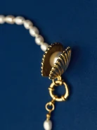 A necklace made of natural pearls with a gold-plated pendant