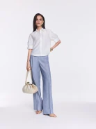 Cream-colored leather handbag with woven detailing