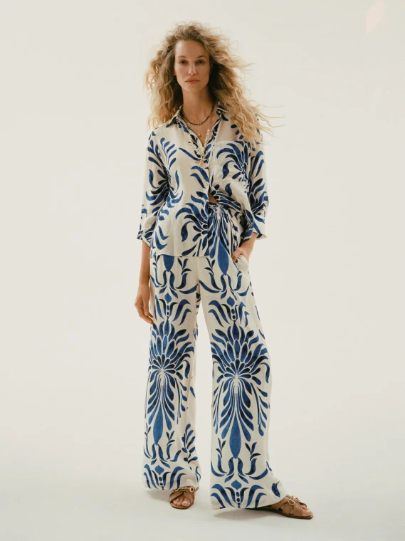 Loose-fitting white pants with an ornamental pattern