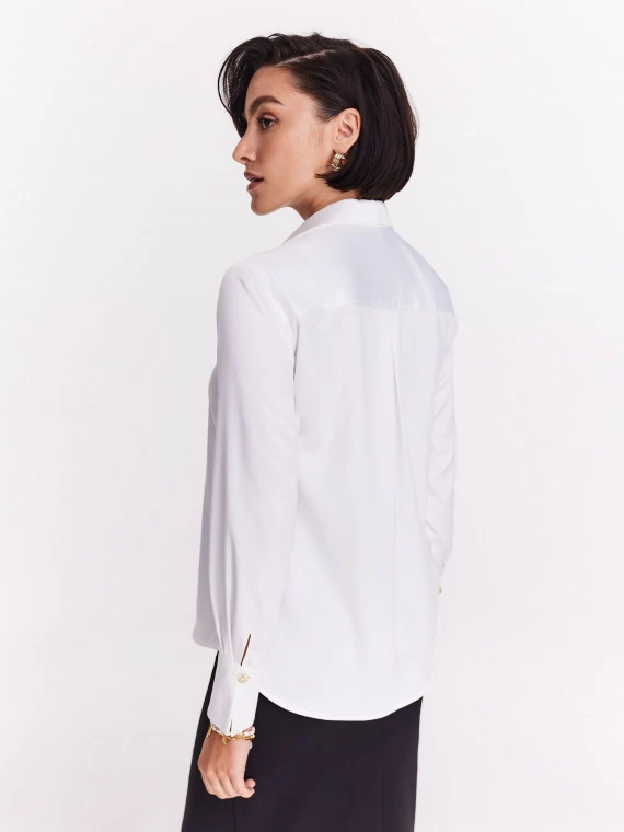 Elegant white shirt with decorative buttons