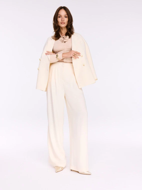 Beige blouse with crease and decorative flower