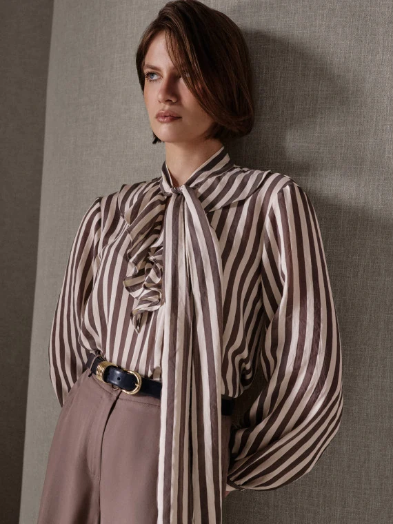 A striped shirt with a sash and a frill