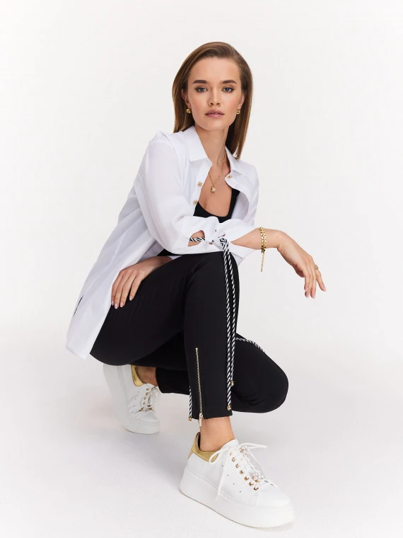 White sneakers with gold heel and pearl embellishments