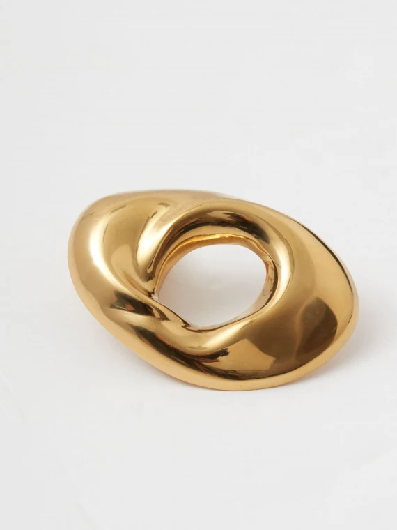 Gold-colored brooch with an irregular shape