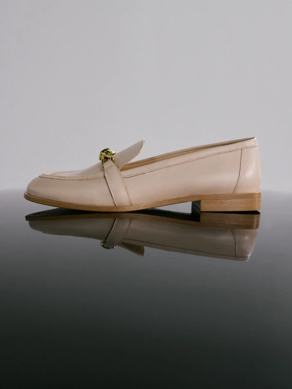 Beige leather moccasins with buckles