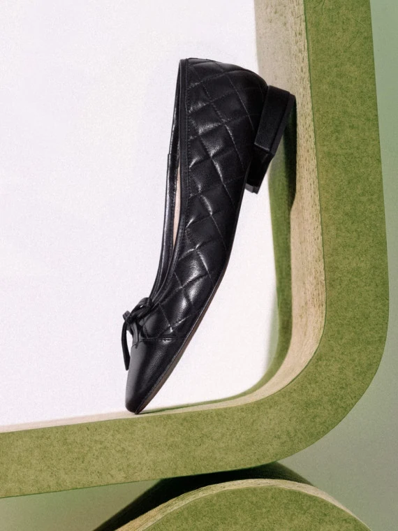 Black quilted leather ballerina flats with bows