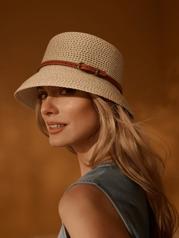 Straw bucket hat with a decorative strap