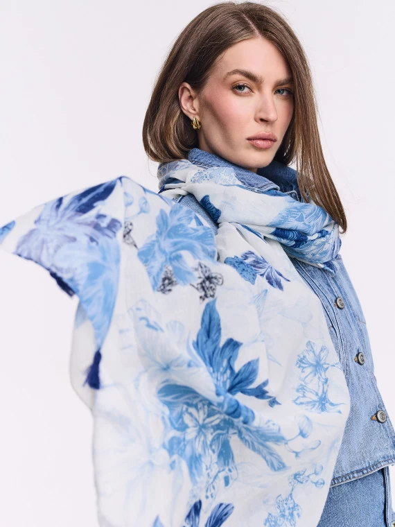 White scarf with blue patterns and decorative tassels