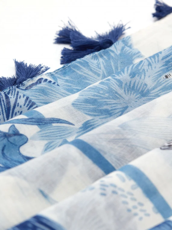 White scarf with blue patterns and decorative tassels