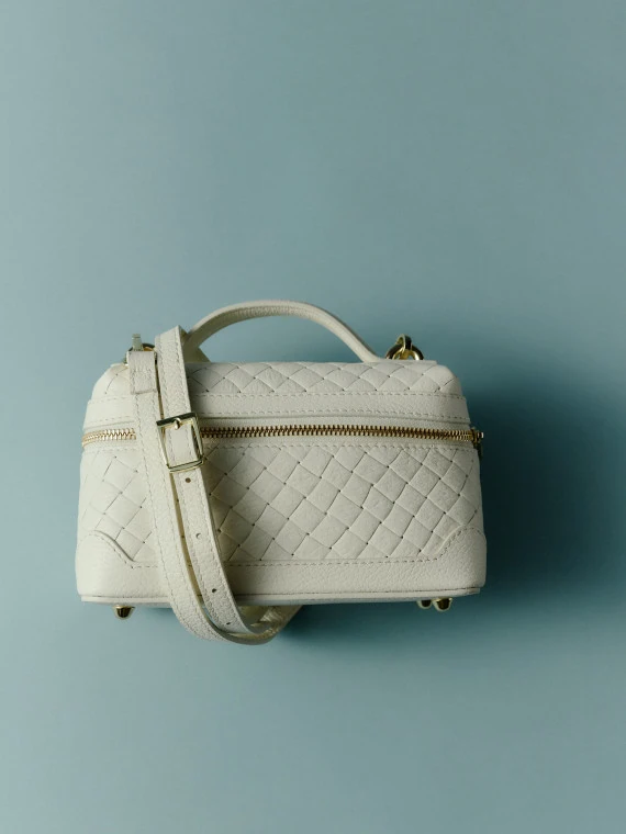 Cream-colored quilted satchel