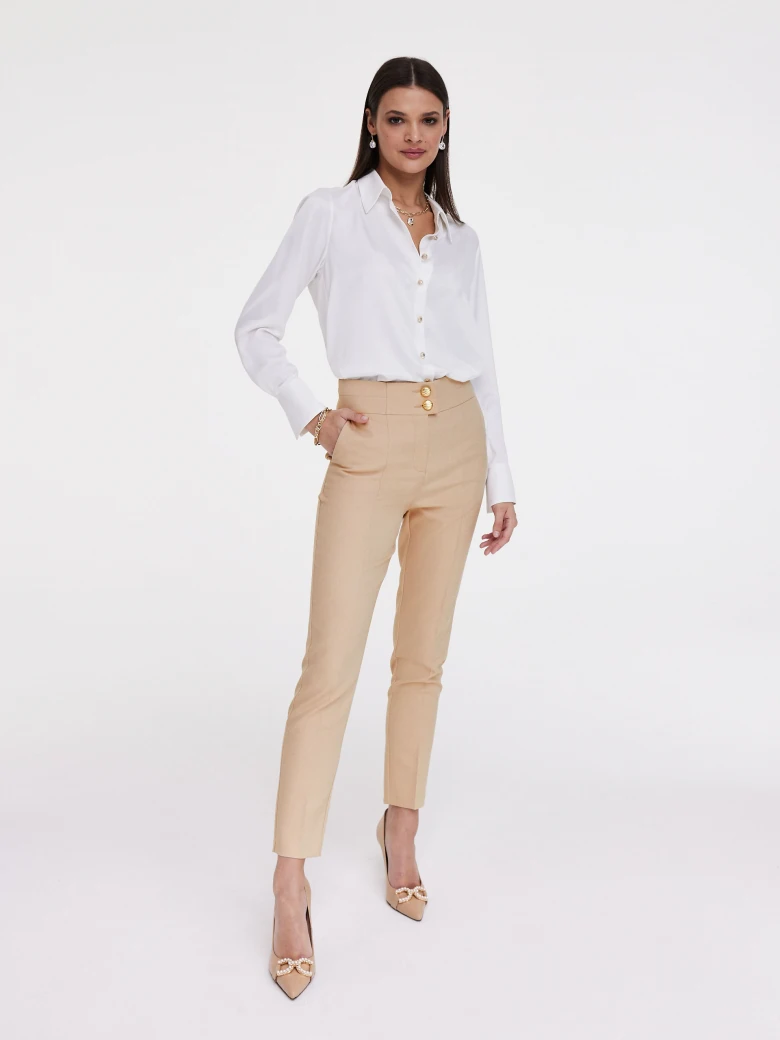 Beige cigarette pants with gold buttons