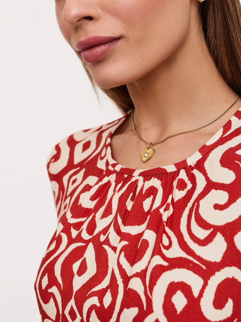 Red and white blouse with ornamental pattern