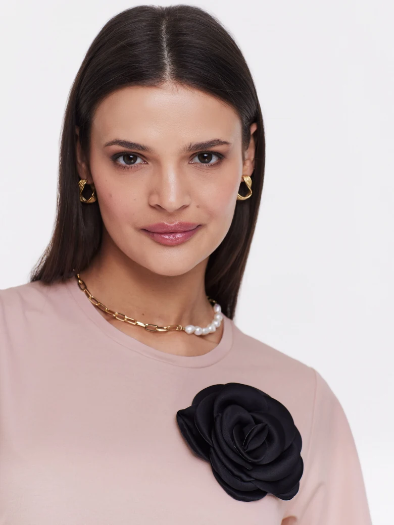 Undersized pink blouse with rose embellishment