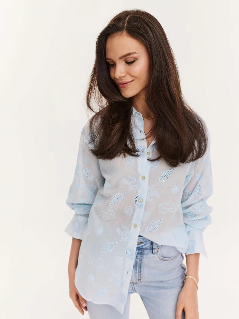 Blue shirt with decorative buttons and openwork inserts