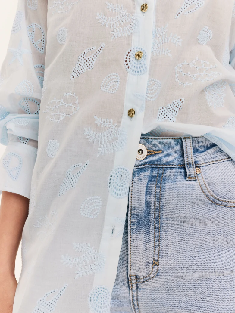 Blue shirt with decorative buttons and openwork inserts