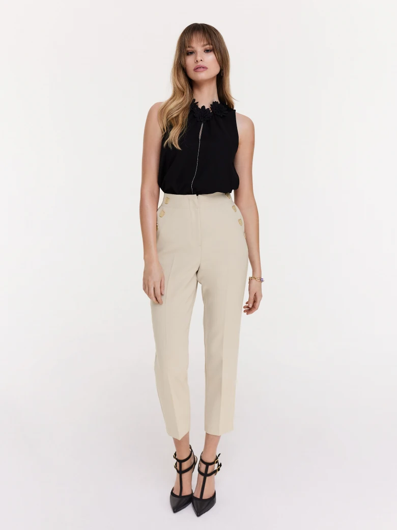 Beige cigarette pants with decorative buttons