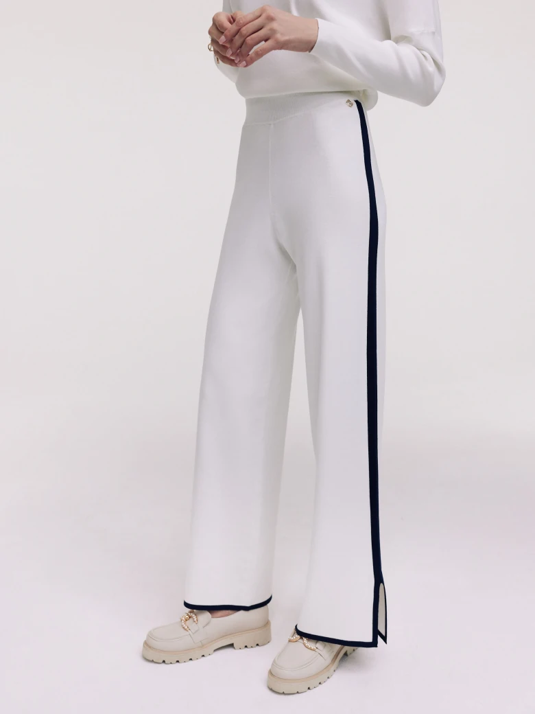 White pants with navy blue piping