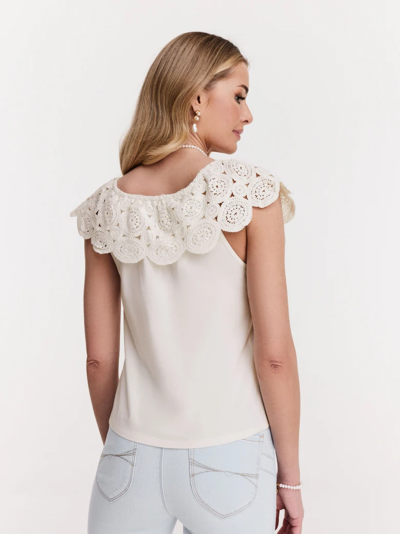 White blouse with lace embellishment at the neckline