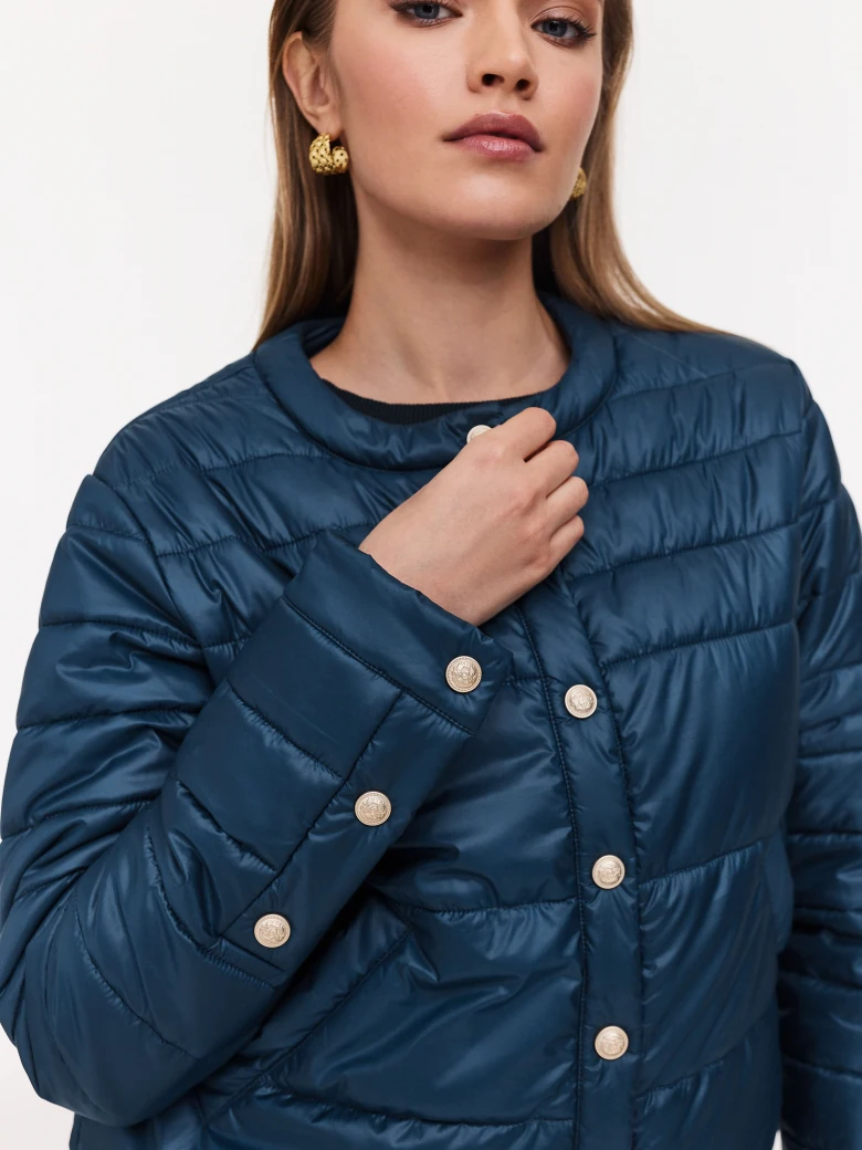 Navy blue quilted jacket with decorative buttons