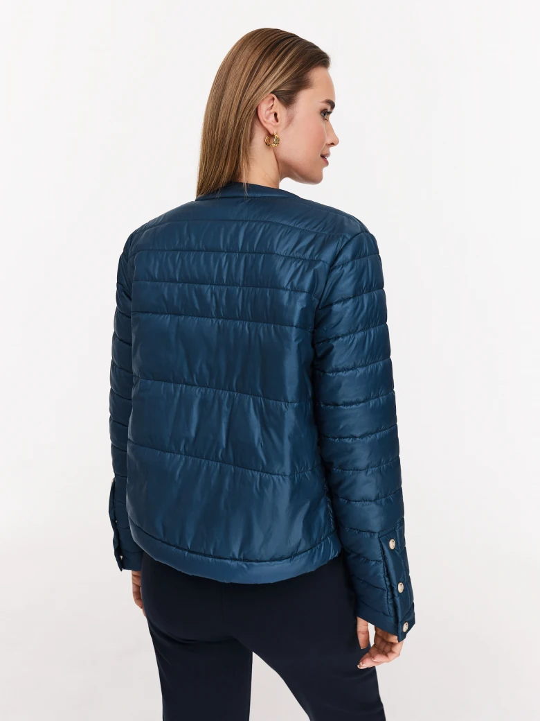 Navy blue quilted jacket with decorative buttons