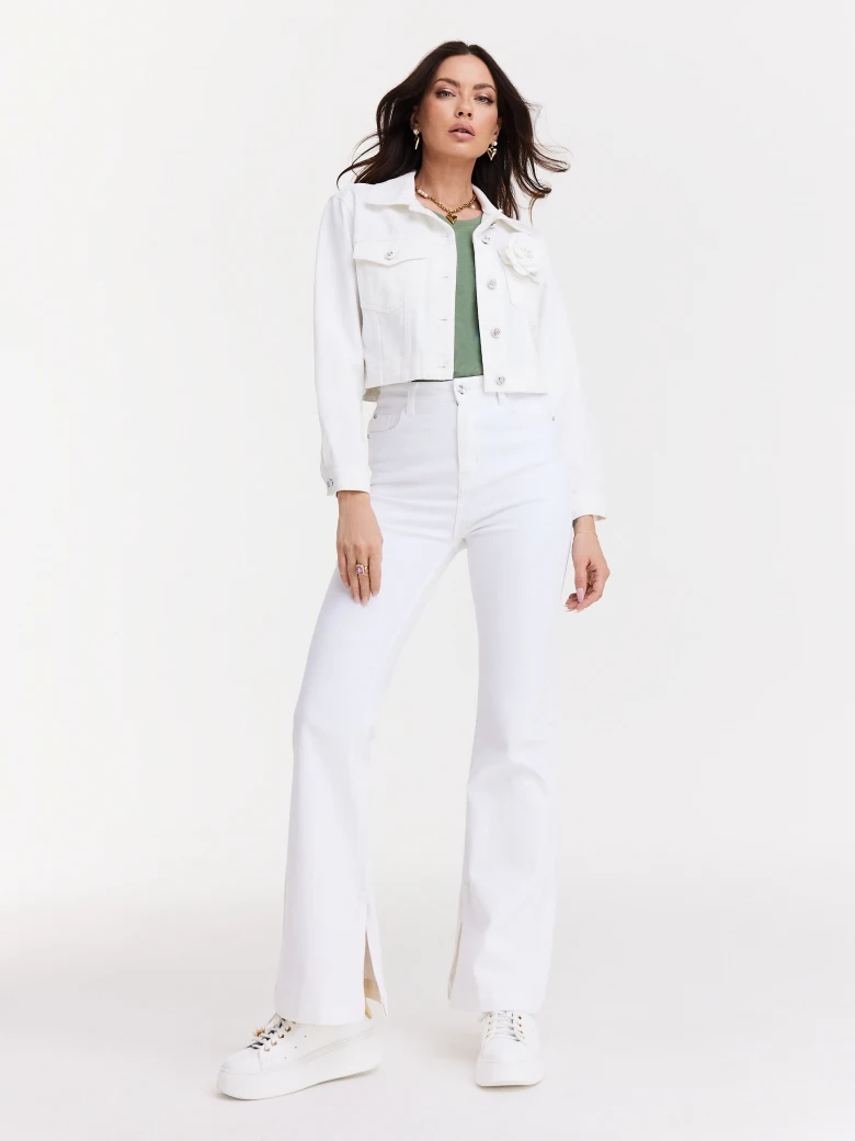 Short white jacket with decorative buttons and rose