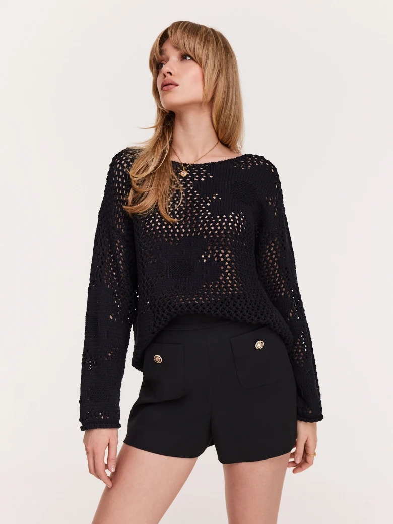 Openwork black sweater with floral elements