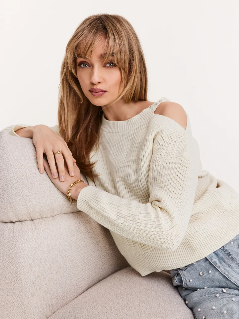 Cream sweater with striking cutouts