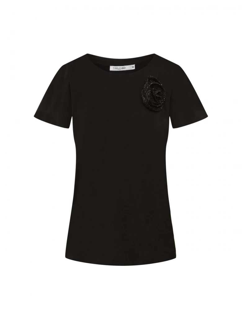 Black short-sleeved blouse with a flower-shaped brooch