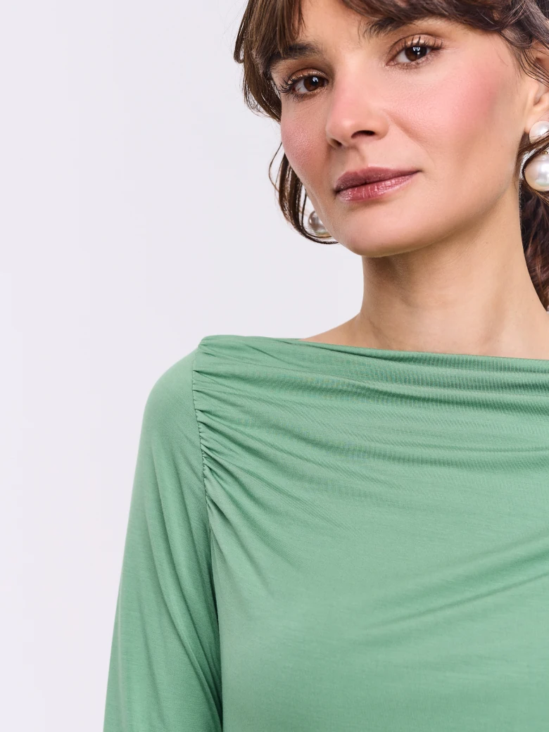 Light green blouse with ruffles and long sleeves