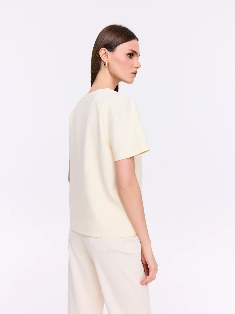 Cream cotton T-shirt with a three-dimensional appliqué