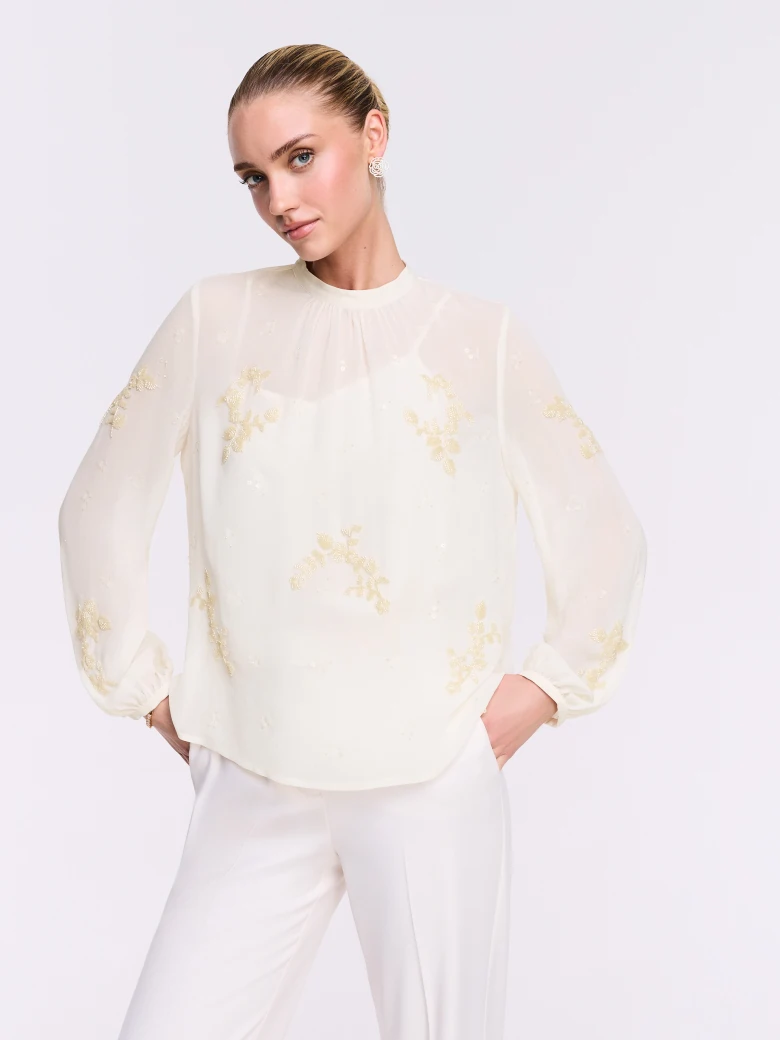An elegant blouse with decorative appliqués